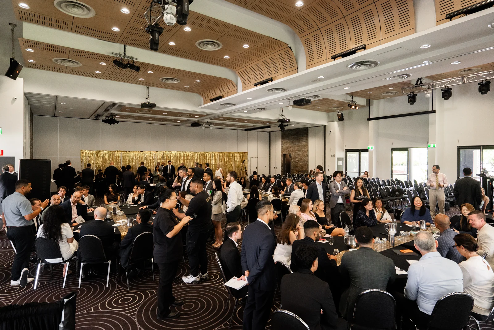 Attendees gathered around tables in the event room.