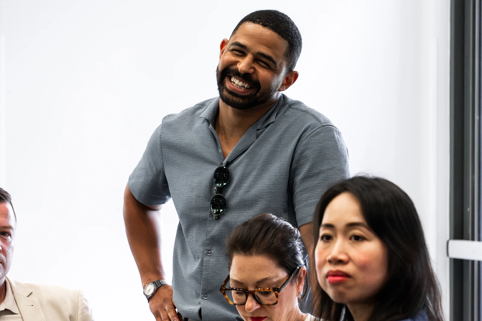 An attendee smiles during a group discussion.