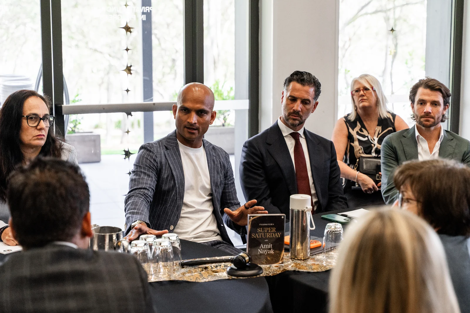 Attendees take part in a discussion around a table.